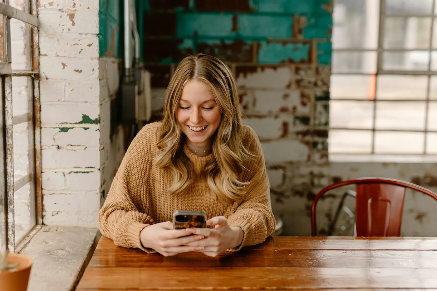 A smiling customer booking on her phone